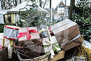 Close up view of a Santa sleigh full of gift boxes and presents for kids excitement. Christmas time fun decoration outside.