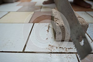 Close up view of a saw cutting concrete block placed on a cerami