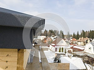 close up view of scaffolding and house under construction with grey folding roof