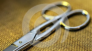 close up view of a scissors on burlap background. Shallow depth of field