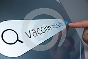 Close-up view of searching information about COVID vaccine side effects