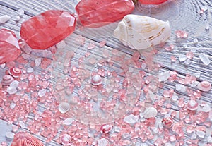 Close up view of seashells,aromatherapy salt and coral necklace.Tender background.