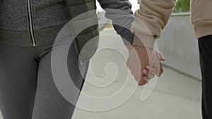 Close up view of the senior couple holding their hands. Lovely elderly people walking together. Happy pensioners. People