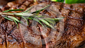 Close up view on serving of marinated grilled rib eye steak with baked potatoes and vegetables