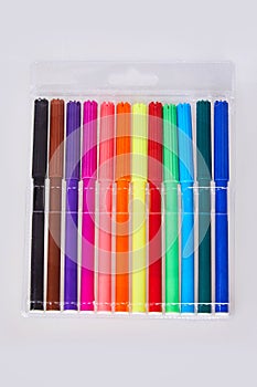 Close-up view of set of colorful felt tip pens in transparent plastic packaging  isolated photo