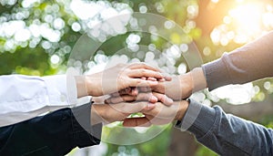 Hands of a diverse group stacked in a gesture of unity and collaboration teamwork stacking