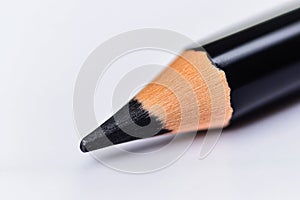 CloseUp View of a Sharp Black Pencil Point on a White Background