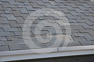 A close up view of shingles a roof damage. Roof Shingles - Roofing.