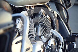 Close up view of a shiny chrome motorcycle design engine with ex