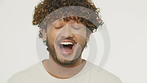 Close-up view of shocked mixed man enjoying good news. Front view of handsome guy with surprised face expression. Wow