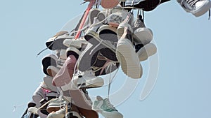 Close-up view of shoefiti in city against clear blue sky, lace are swaying by wind in summer day