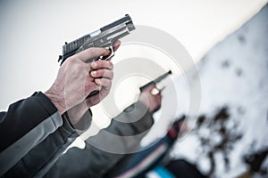 Close-up view of shooter practice handgun shooting in row group
