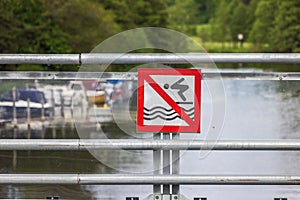 Close-up view of sign prohibited diving from bridge.