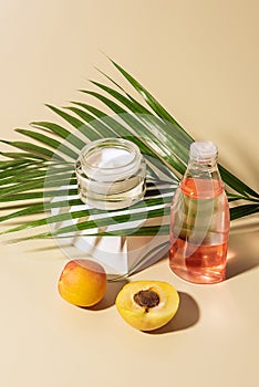 close up view of skin care products apricots and green palm leaf