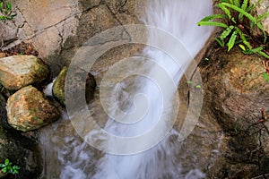 Close-up view of small waterfall into pond in rural in Hong Kong with slow shutter.