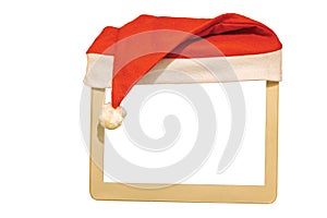 Close up view of small white mockup image blank board with red Santa hat over top.