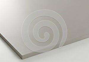 A close-up view of a smooth, light gray, textured surface. The material