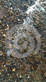 Close up view of smooth round pebble stones on the beach.