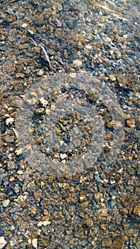 Close up view of smooth round pebble stones on the beach.