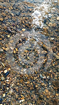 Close up view of smooth round pebble stones on the beach.