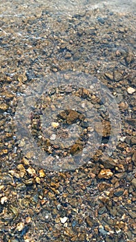 Close up view of smooth round pebble stones on the beach.