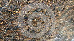 Close up view of smooth round pebble stones on the beach.