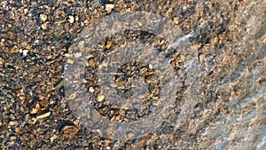 Close up view of smooth round pebble stones on the beach.