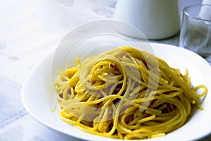 Close up view of spaghetti carbonara. Typical Italian recipe. The main ingredients are eggs, parmesan cheese, pecorino cheese and