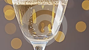 Close up view of sparkling champagne Glass in slow motion