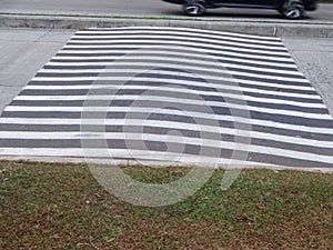 close up view of a speed bump with zebra stripes