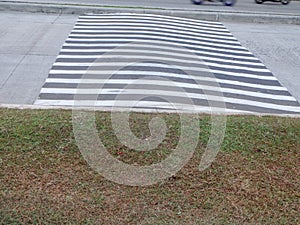 close up view of a speed bump with zebra stripes
