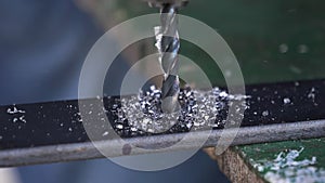 Close-up view of spinning metal spiral drill bit