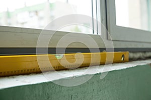 Close-Up View of a Spirit Level Tool on a Window Ledge During Daytime Construction Work