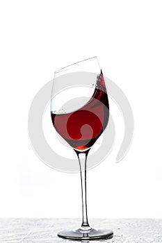 Close up view of splashing red wine in glass isolated on white background