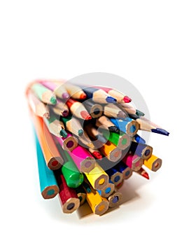 Close up view of stack of colorful pencils on white background