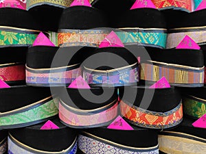 Close up view stack of Songkok or traditional songkok hat for muslims isolated on white background photo