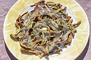 Close-up view of string beans dried under the sunlight on the plate