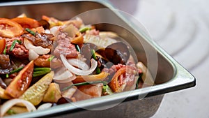 Close-up view of sweet and sour stir fry filled with pork pieces