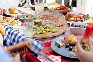 Close up view of a table set during a family lunch in the garden