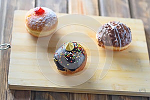 Close up view of tasty various donuts on wood background. Hanukkah celebration concept.