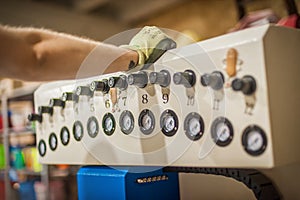 Close-up view of technician work on control panel in factory