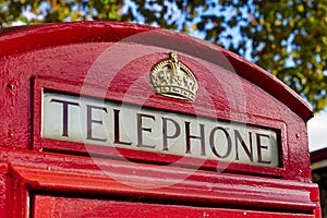 Close-Up view of Telephone sign on Red Telephone Box in London,UK