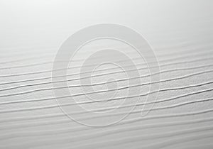 A close-up view of a textured white surface with parallel lines running horizontally