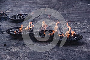 Close up view of three sacred flames burning in a platter. Preparation for burial.Preparation for burial ceremony.