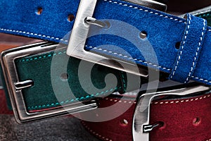 Close-up view of three suede belts