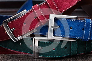 Close-up view of three suede belts