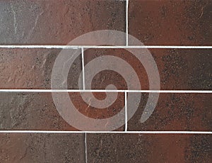 Close Up view of tile brick ceramic granite panels made in the color of brown. Fragment of the surface of the wall. can be used as photo