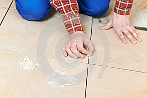 Tiler hands at home renovation work photo