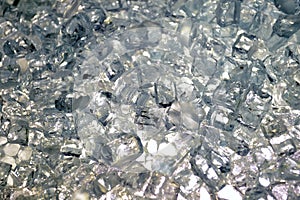 Close-up view to chaotic agglomeration of cubes of alimentary ice for bar beverages.