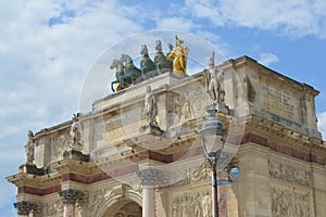 Close up view to statues on Arc de Triomphe du Carrousel in Place du Carrouse yard